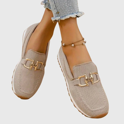 View of elegant women's loafers in soft beige, featuring breathable fabric and a sleek design