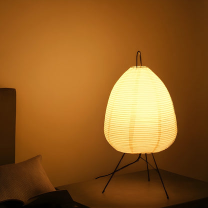 View of a serene minimalist rice paper table lamp featuring a soft white shade and a natural wood base, ideal for living room decor