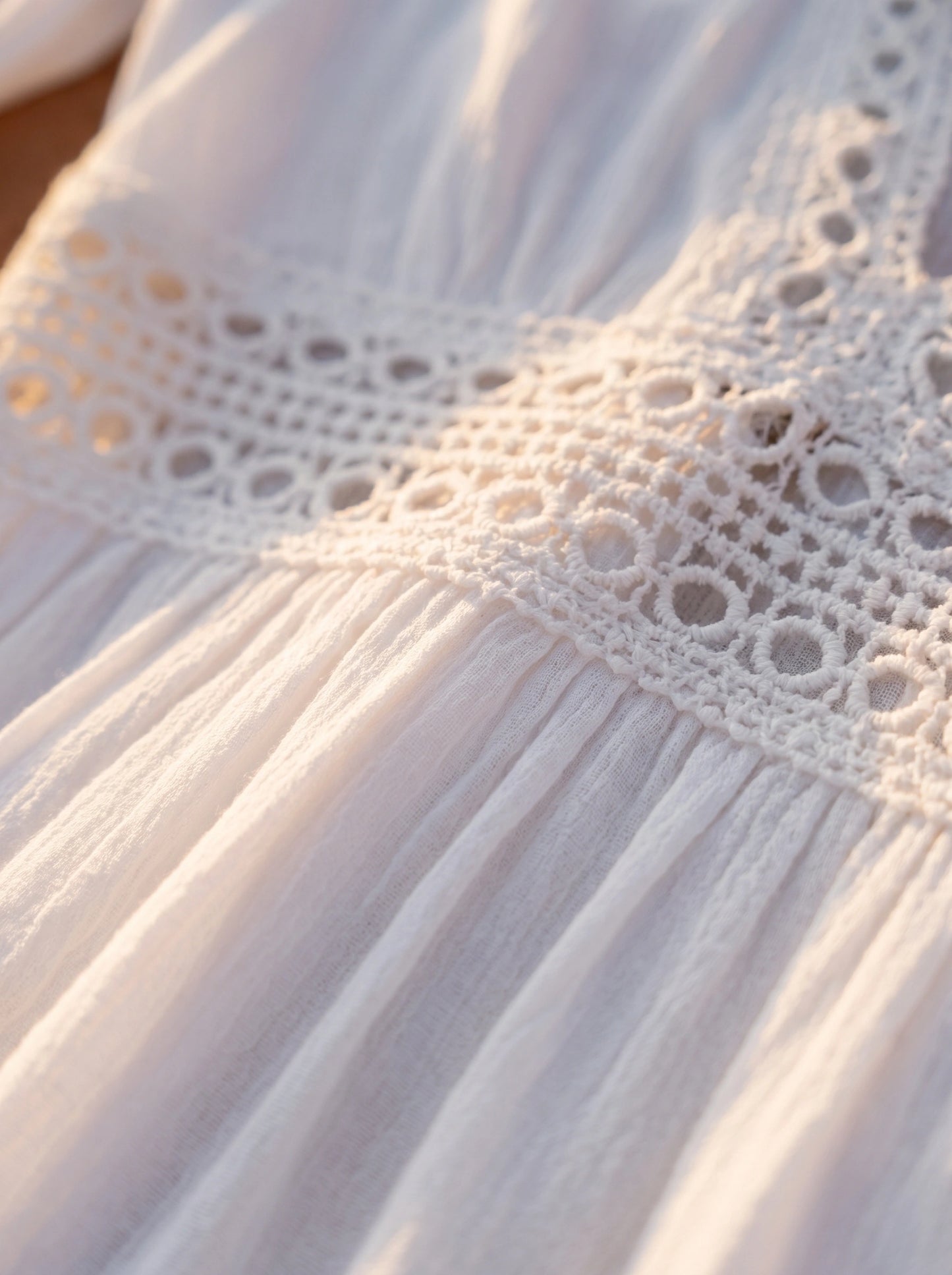 Close up view of the Womens Breezy Summer Dress showing its lightweight fabric, delicate stitching, and flowing silhouette against a soft beach background.