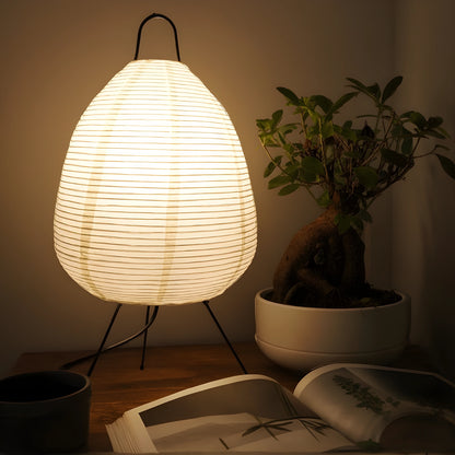 View of a serene minimalist rice paper table lamp, featuring a soft white shade and a natural wood base, ideal for living room decor