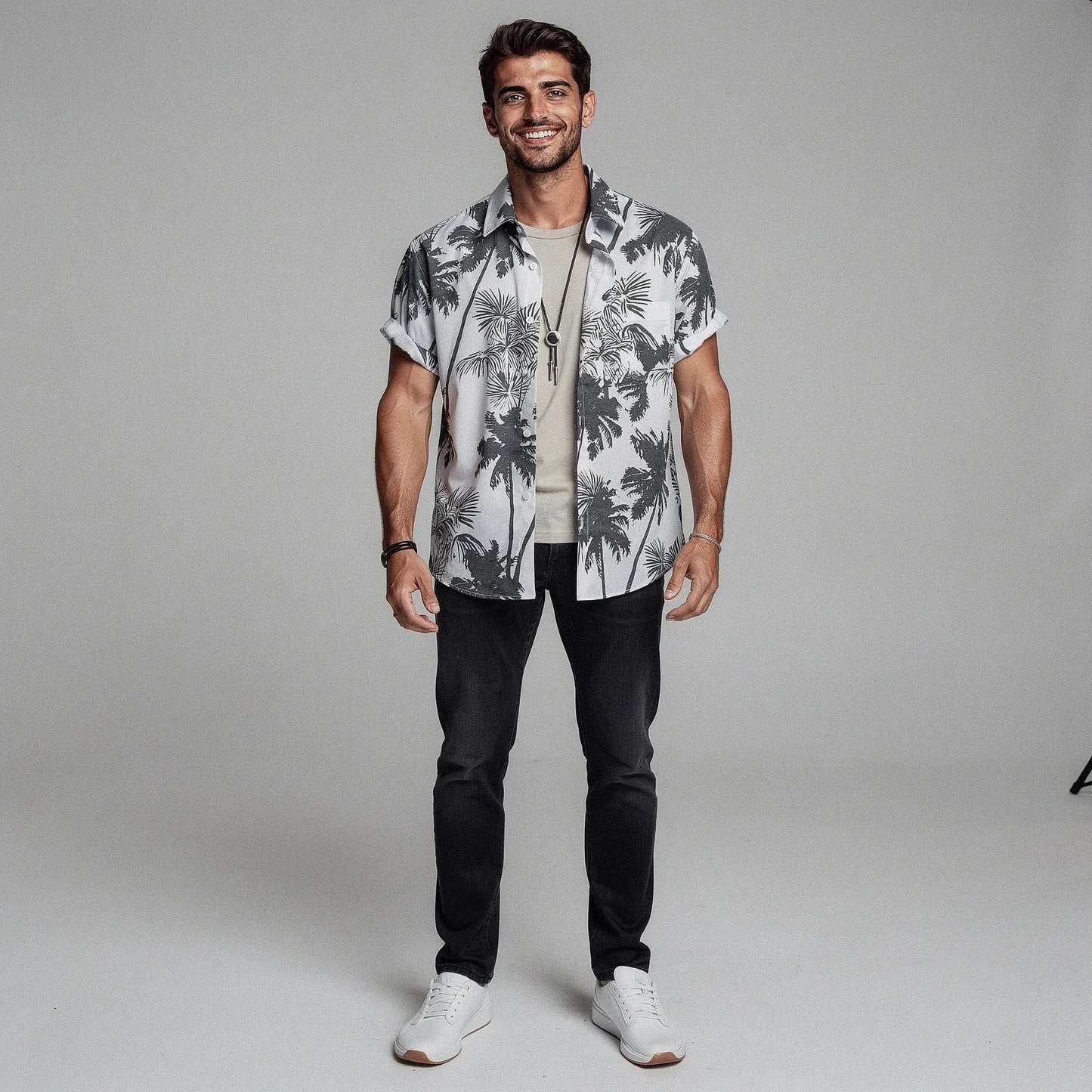 View of a slim fit short sleeve Hawaiian shirt featuring a vibrant floral print in shades of blue and green