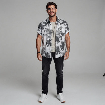 View of a slim fit short sleeve Hawaiian shirt featuring a vibrant floral print in shades of blue and green