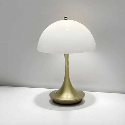 View of a sleek contemporary rechargeable table lamp in a warm brass finish, featuring a minimalist design and a soft white shade