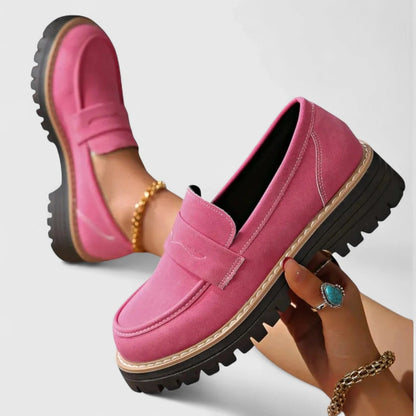 View of elegant women's loafers in soft beige leather, featuring a classic slip on design and cushioned insole