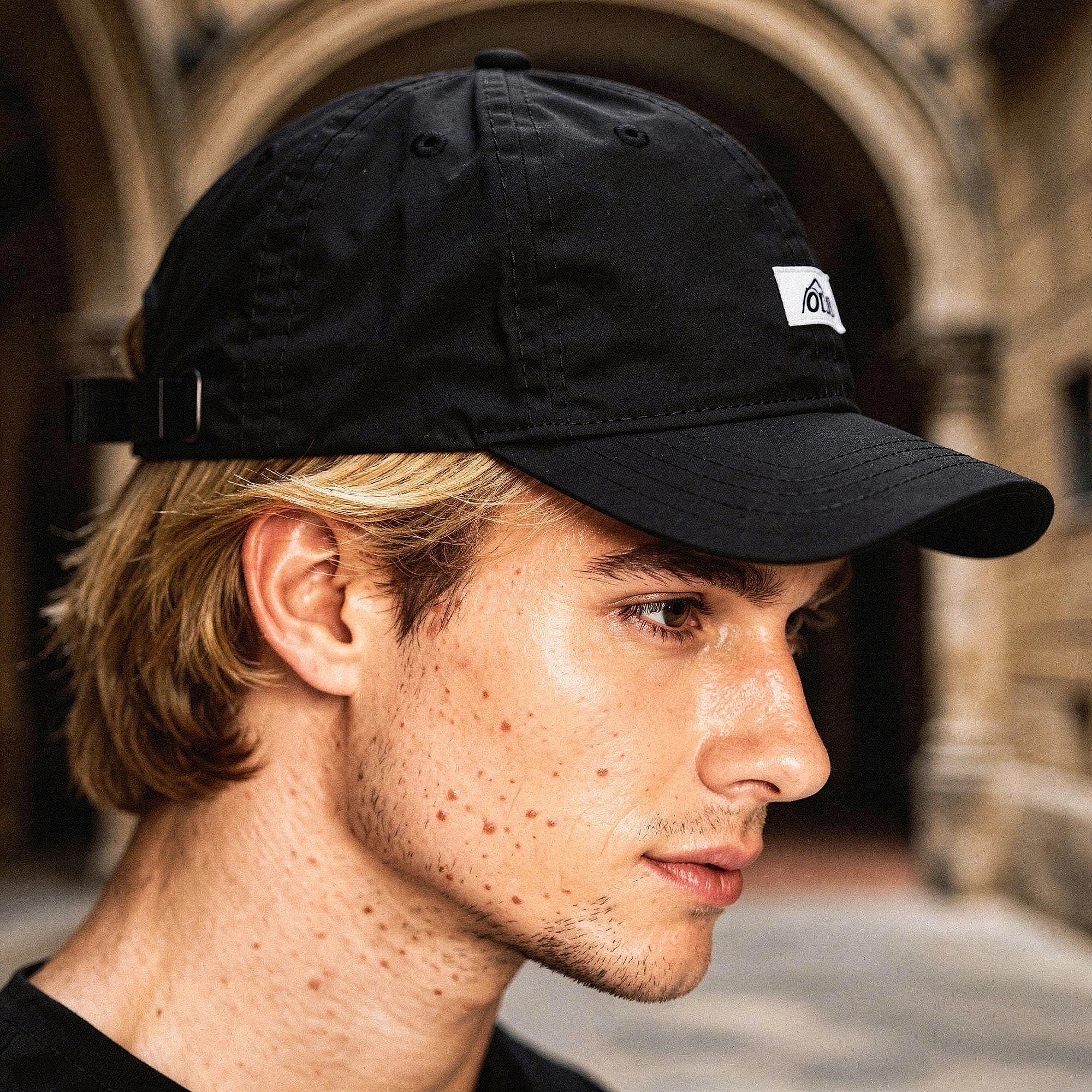 View of a stylish men's baseball cap in dark gray, featuring breathable fabric and a curved brim