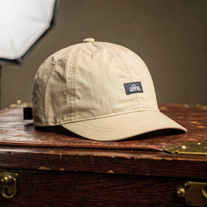 View of a stylish black baseball cap made of breathable fabric, featuring a curved brim and adjustable strap