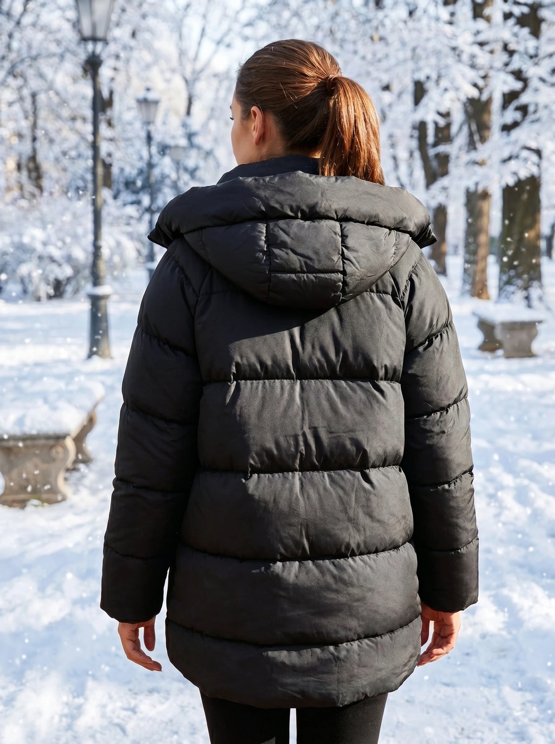 Close up of the women's oversized winter puffer jacket showing the luxurious fabric, intricate stitching, and design elements against a neutral background.