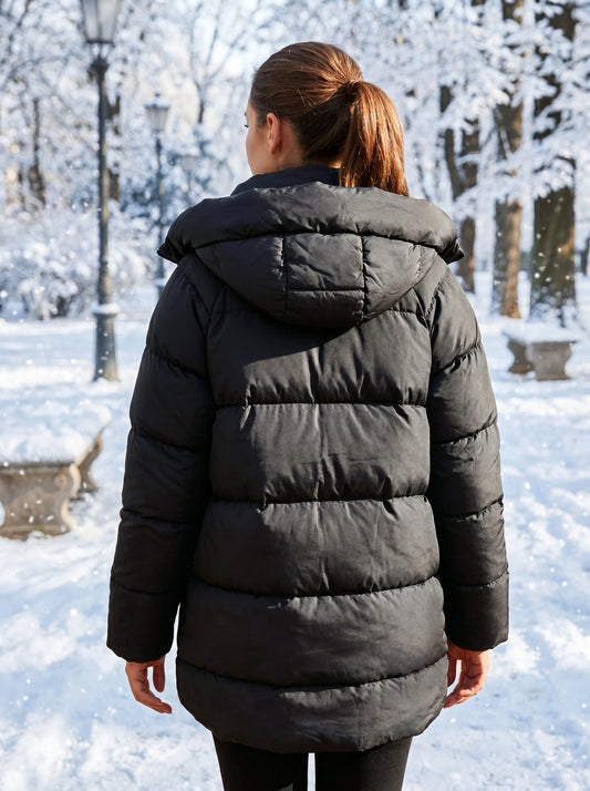 Close up of the women's oversized winter puffer jacket showing the luxurious fabric, intricate stitching, and design elements against a neutral background.