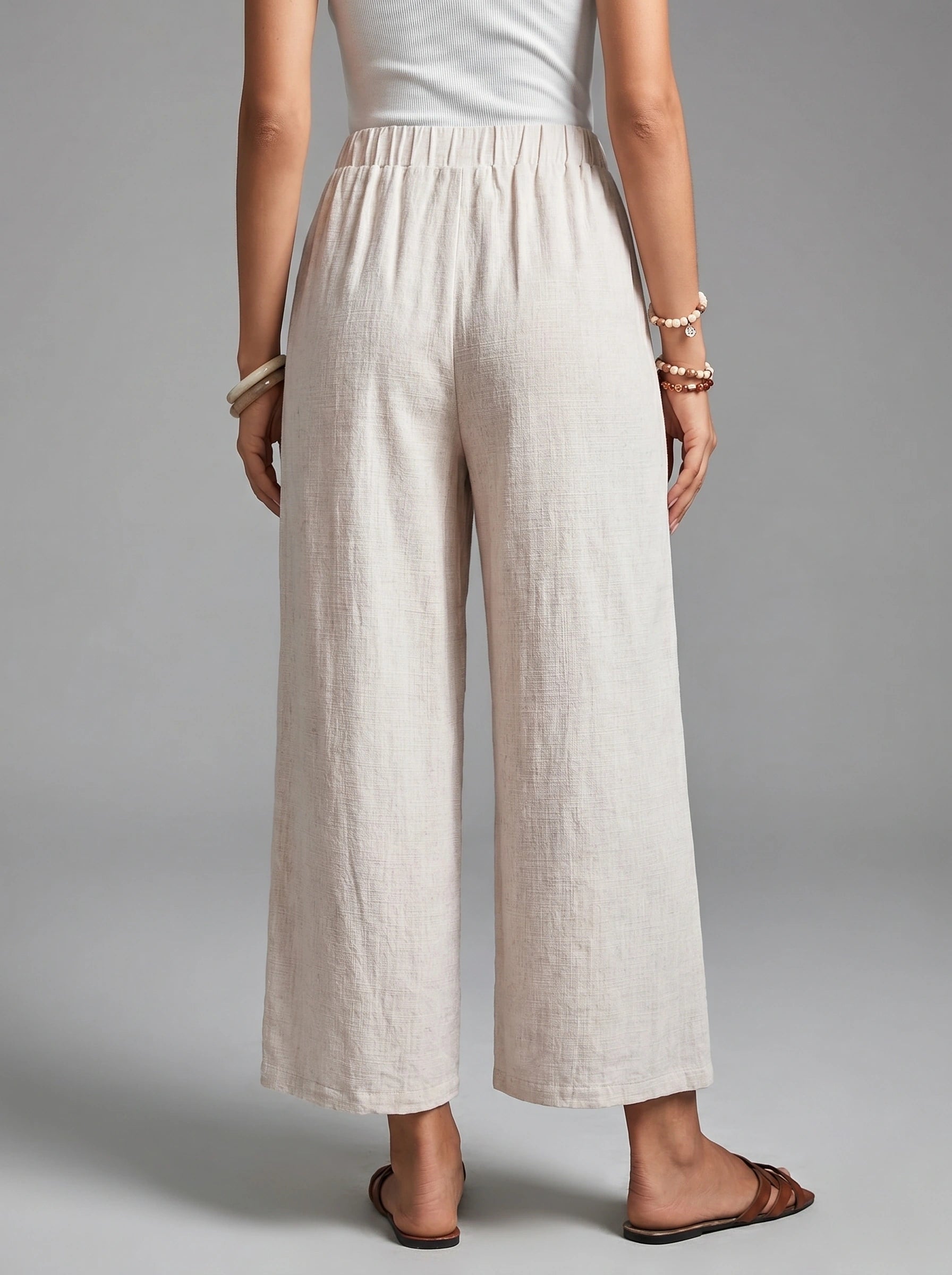 Close up view of the Womens Effortless Spring Trousers showing the high waisted design, button details, and soft fabric texture against a neutral background.