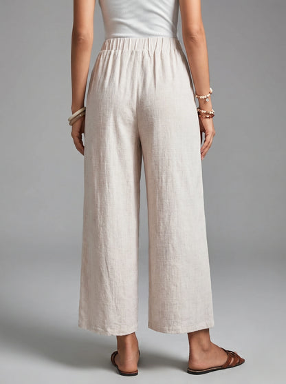 Close up view of the Womens Effortless Spring Trousers showing the high waisted design, button details, and soft fabric texture against a neutral background.