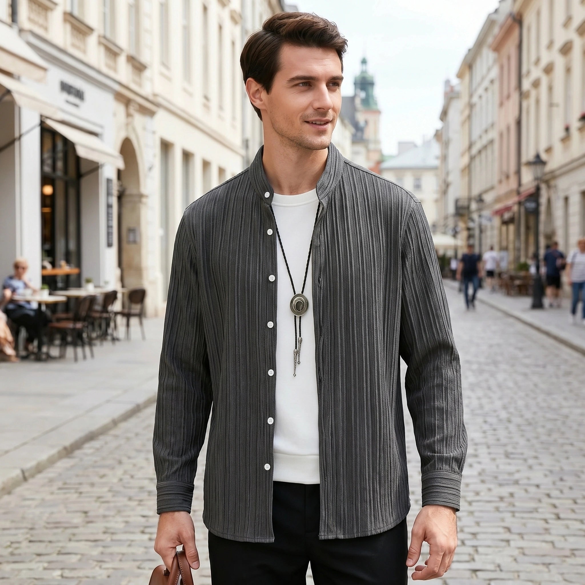 A male model showcases a relaxed fit textured spring shirt in a soft pastel color, styled with casual trousers against a neutral background.