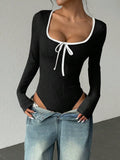 Black U neck bodysuit with white bowknot and long sleeves, paired jeans