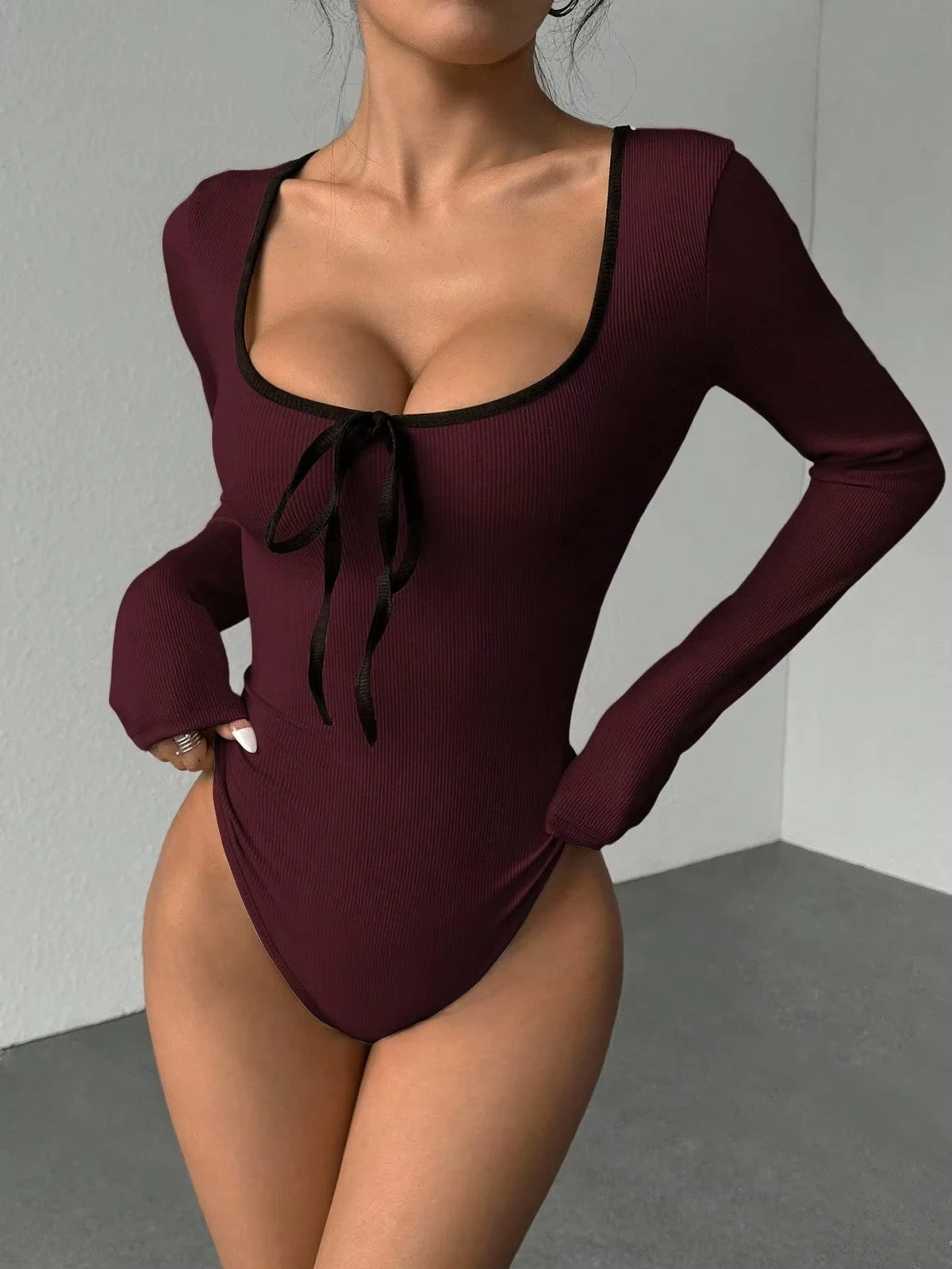 Maroon U neck bodysuit with black bowknot and long sleeves, close up view — 17 — view 17