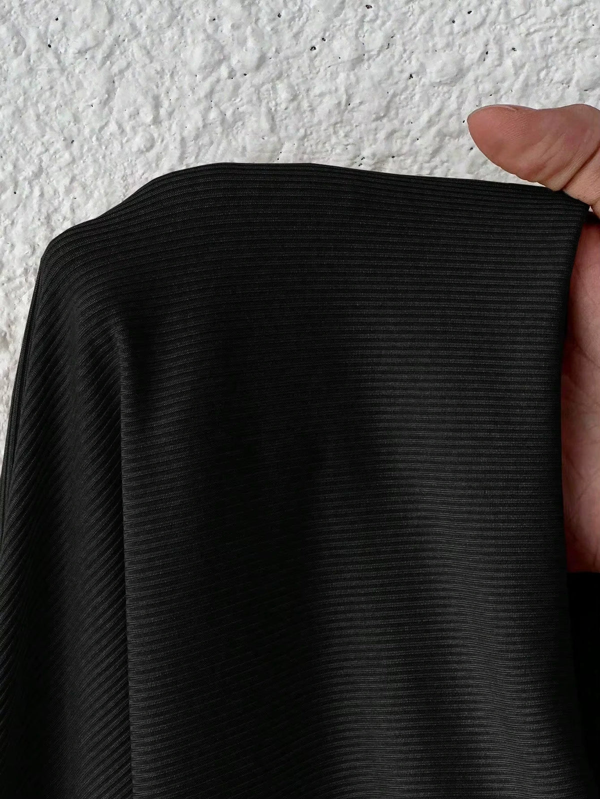 Close up of black ribbed fabric, showcasing texture and detail the bodysuit material — view 6 — view 6