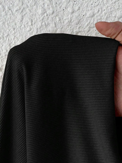 Close up of black ribbed fabric, showcasing texture and detail the bodysuit material — view 6 — view 6