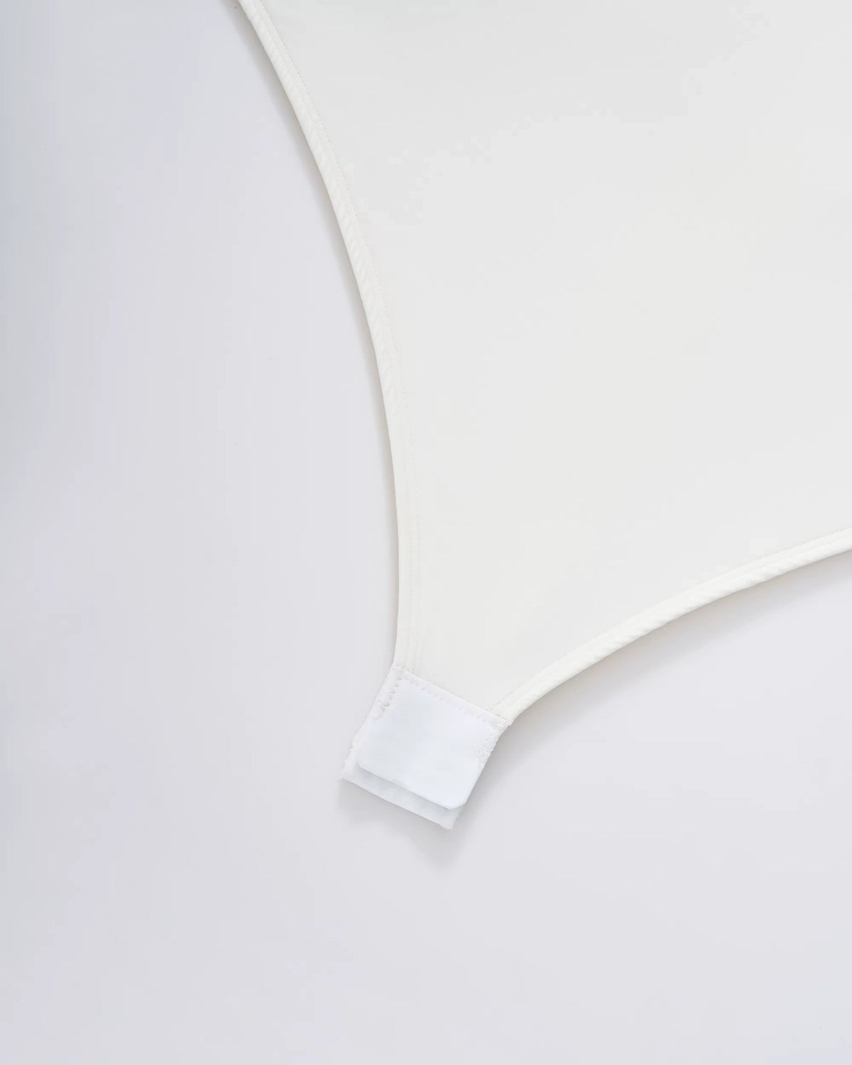 Close up of white fabric with snap closure detail on a bodysuit — view 12 — view 12