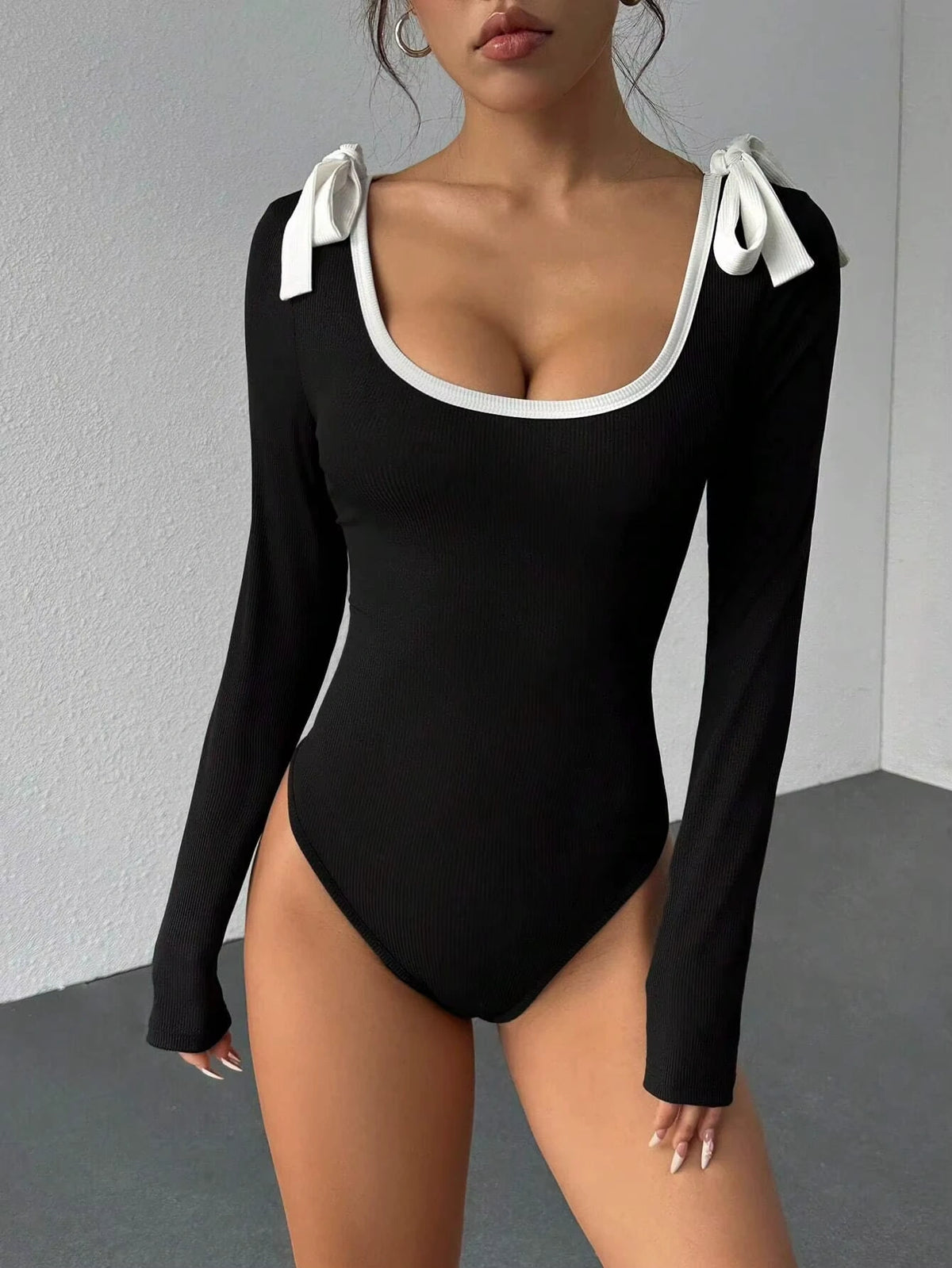 Black rib knit long sleeve bodysuit with white bow details on shoulders — view 12 — view 12