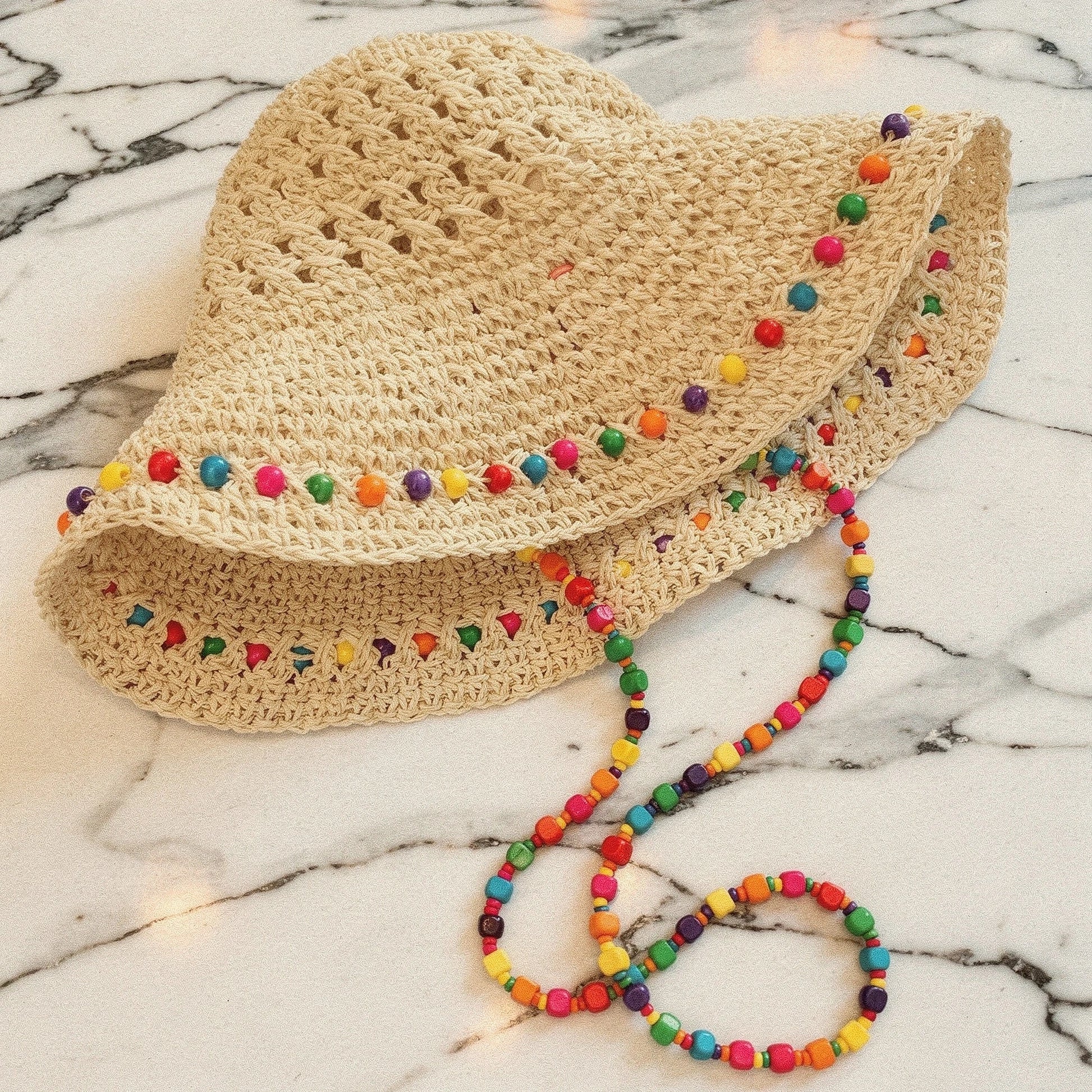 Colorful crochet bucket hat featuring a wide brim, detailed stitching, and a summer ready design, view