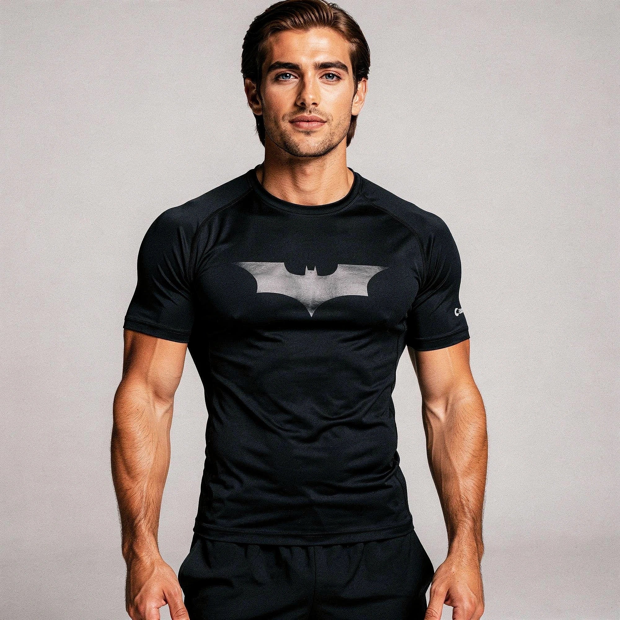 View of a fitted black athletic compression running tee made from moisture wicking fabric with short sleeves