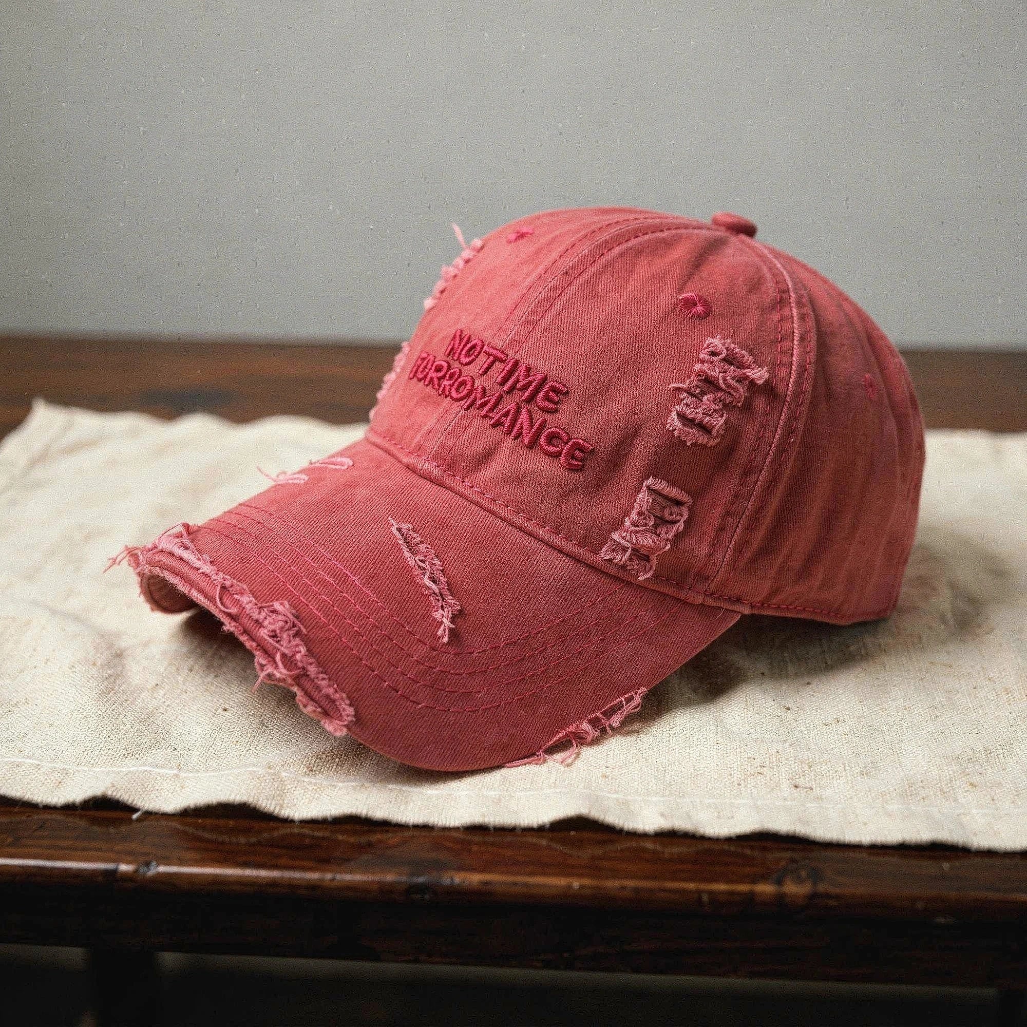 Light blue distressed baseball cap with a curved brim, adjustable strap, and subtle frayed detailing, view