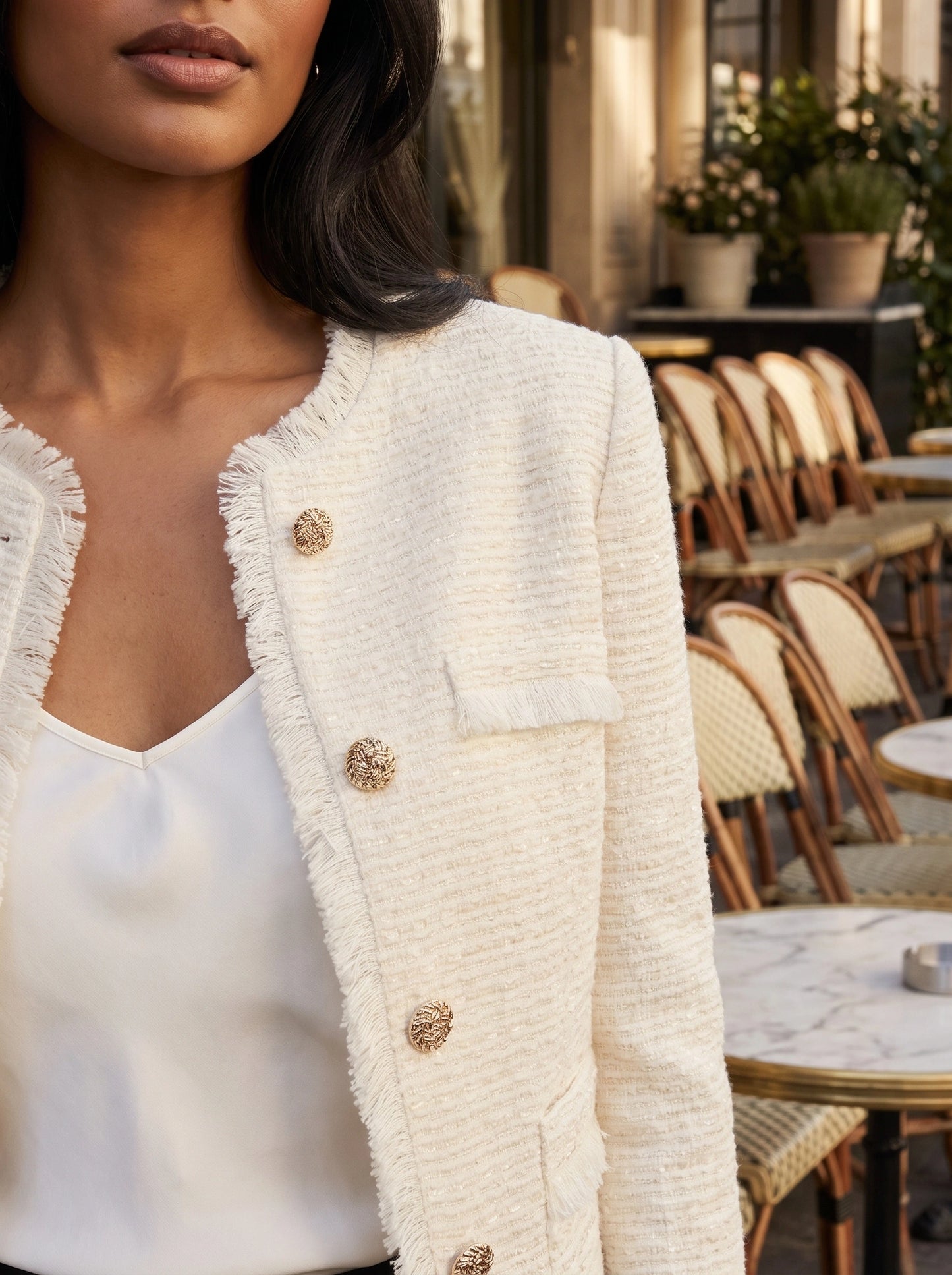 Back view of a model wearing a womens textured spring crop jacket in a soft pastel color, showing its construction details against a neutral background.