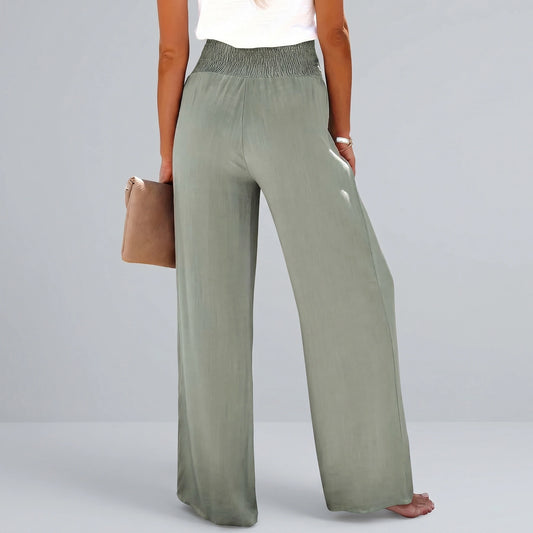 Back view of a model wearing high waisted Womens Effortless Summer Trousers in KF046 color, showing the tailored construction and flowy fabric against a neutral background.