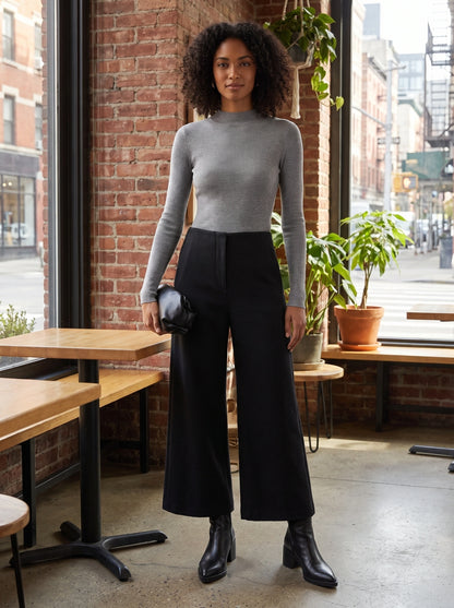 Front view of a model showing women's tailored autumn cropped trousers in a warm beige color, styled with a complementary top against a neutral background.