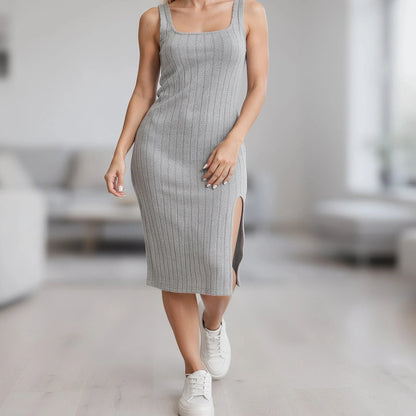 View of a relaxed knitted midi dress in soft beige, featuring a slit and a comfortable fit