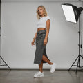 View of a chic, flattering midi skirt in a soft fabric, featuring a stylish silhouette and elegant drape
