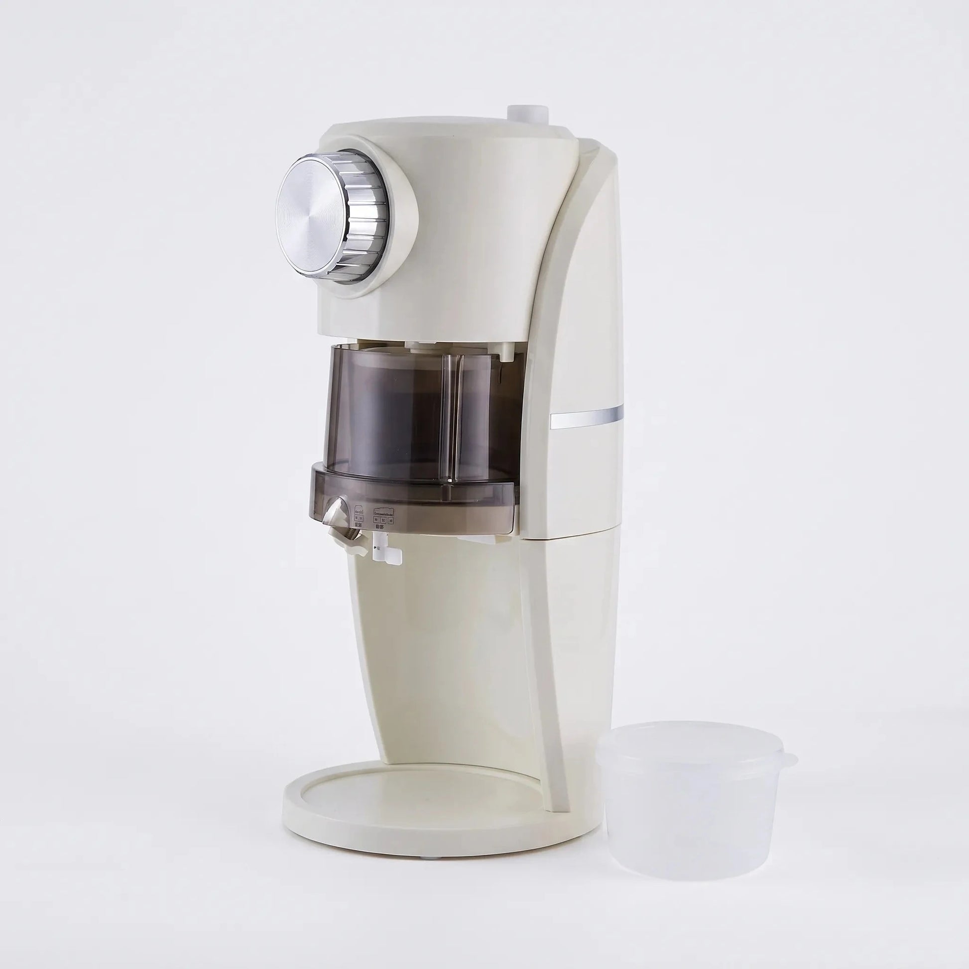 View of a sleek electric mini ice shaver, showcasing its compact design and functional ice bowl