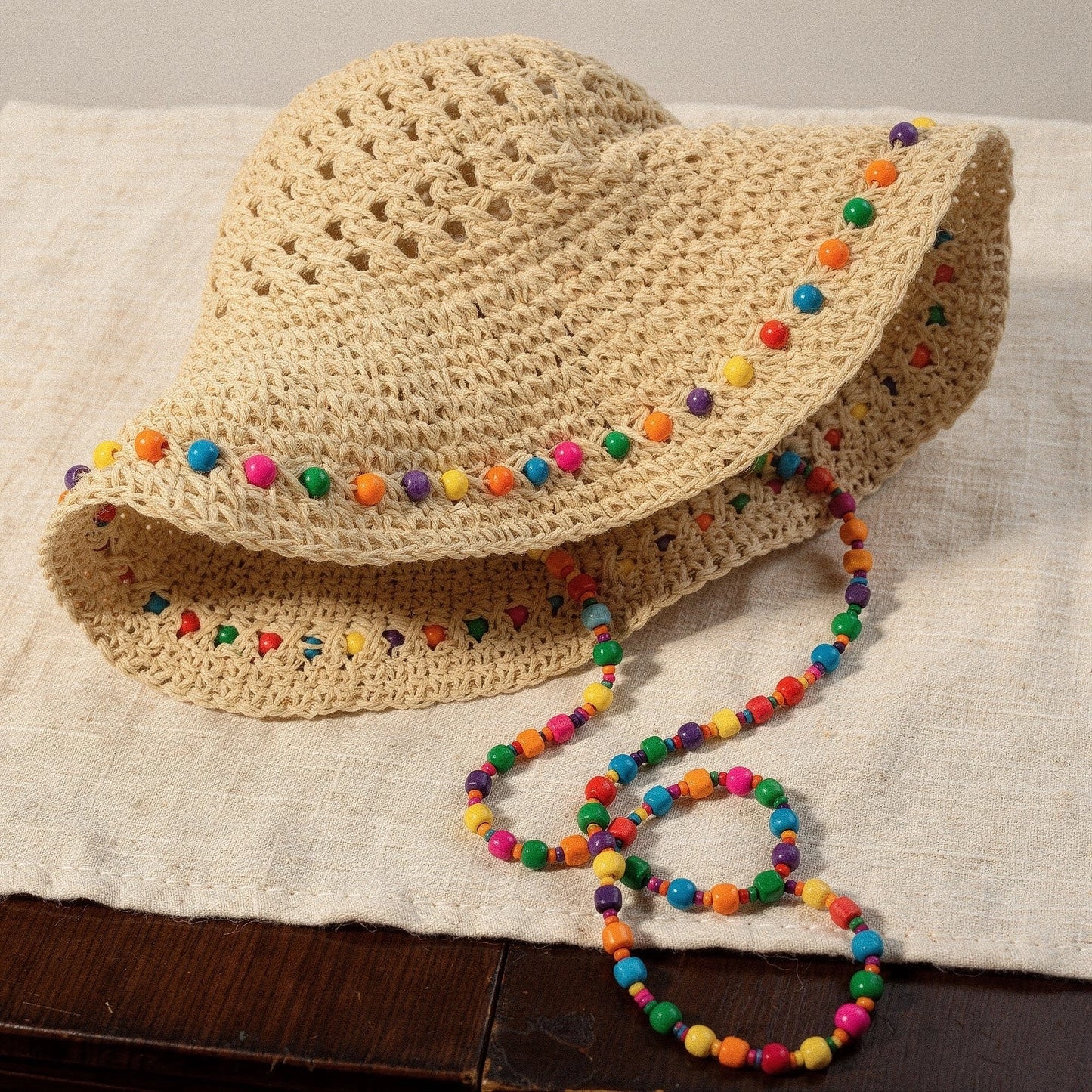 Colorful crochet summer bucket hat with a wide brim and intricate patterns, showcasing vibrant hues and a detailed texture