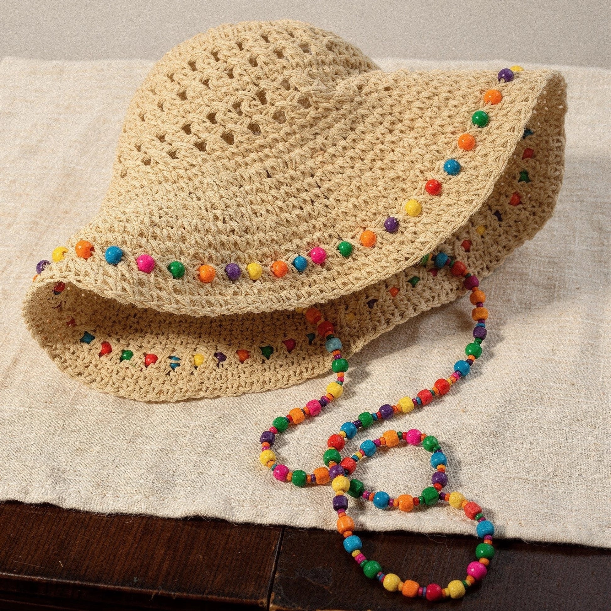 Colorful crochet summer bucket hat with a wide brim and intricate patterns, showcasing vibrant hues and a detailed texture