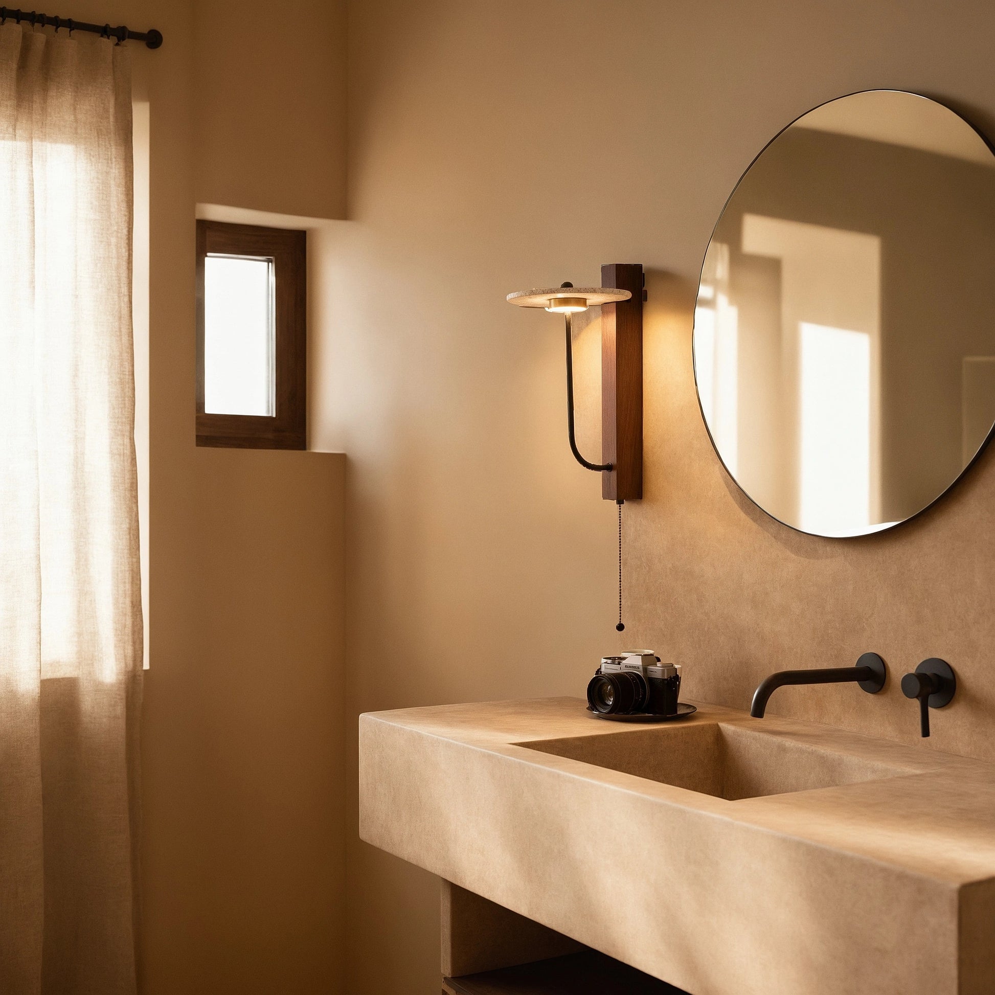 View of a natural stone wall sconce featuring earthy tones, textured surface, and a warm ambient glow