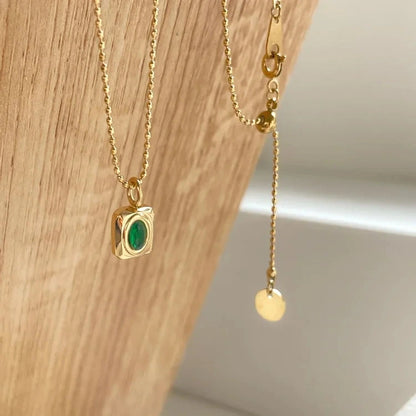View of a vintage necklace featuring a delicate chain and a stunning peridot gemstone pendant, showcasing its refined design