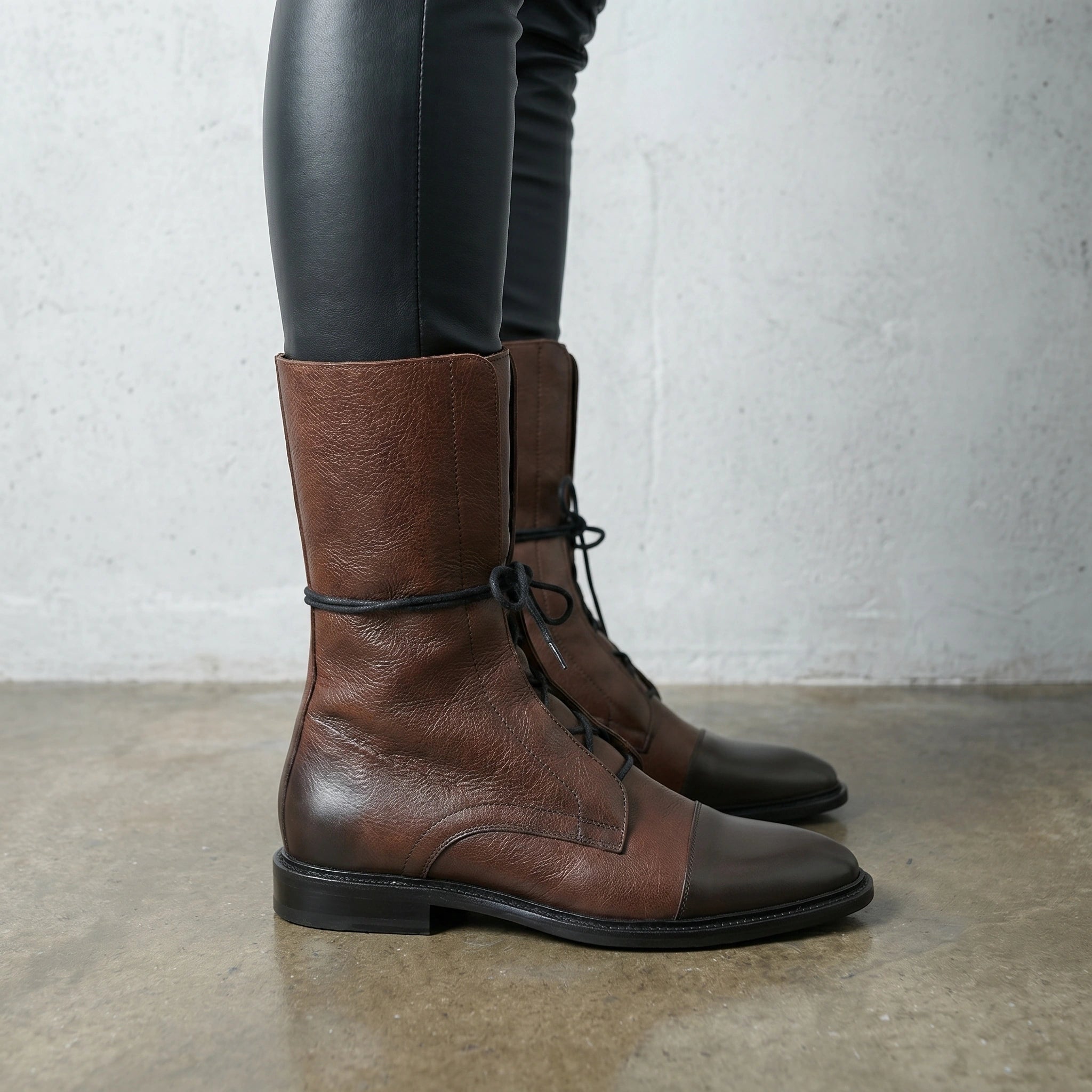 A model showcases the Womens Edgy Minimalist Ankle Boots in black, paired with a outfit against a neutral background for a look.