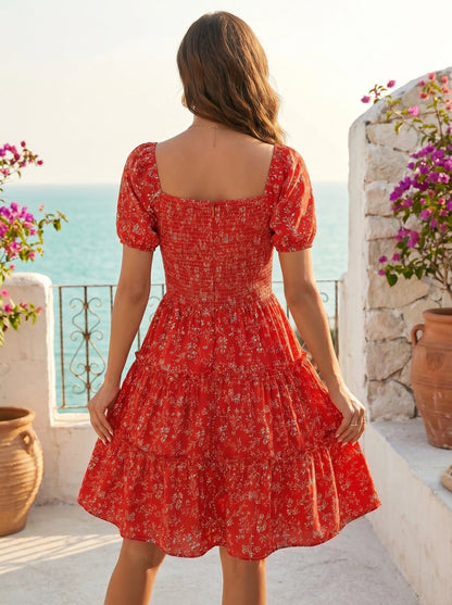Back view of a model wearing a women's slim summer dress in a soft pastel color, showing the construction details against a sunny beach backdrop.