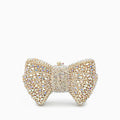 Elegant clutch bag in soft leather with a sleek silhouette, featuring gold tone clasp and detachable chain strap