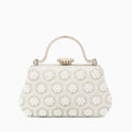 Elegant pearl clutch bag featuring a smooth finish, adorned with delicate clasp, shown in front view