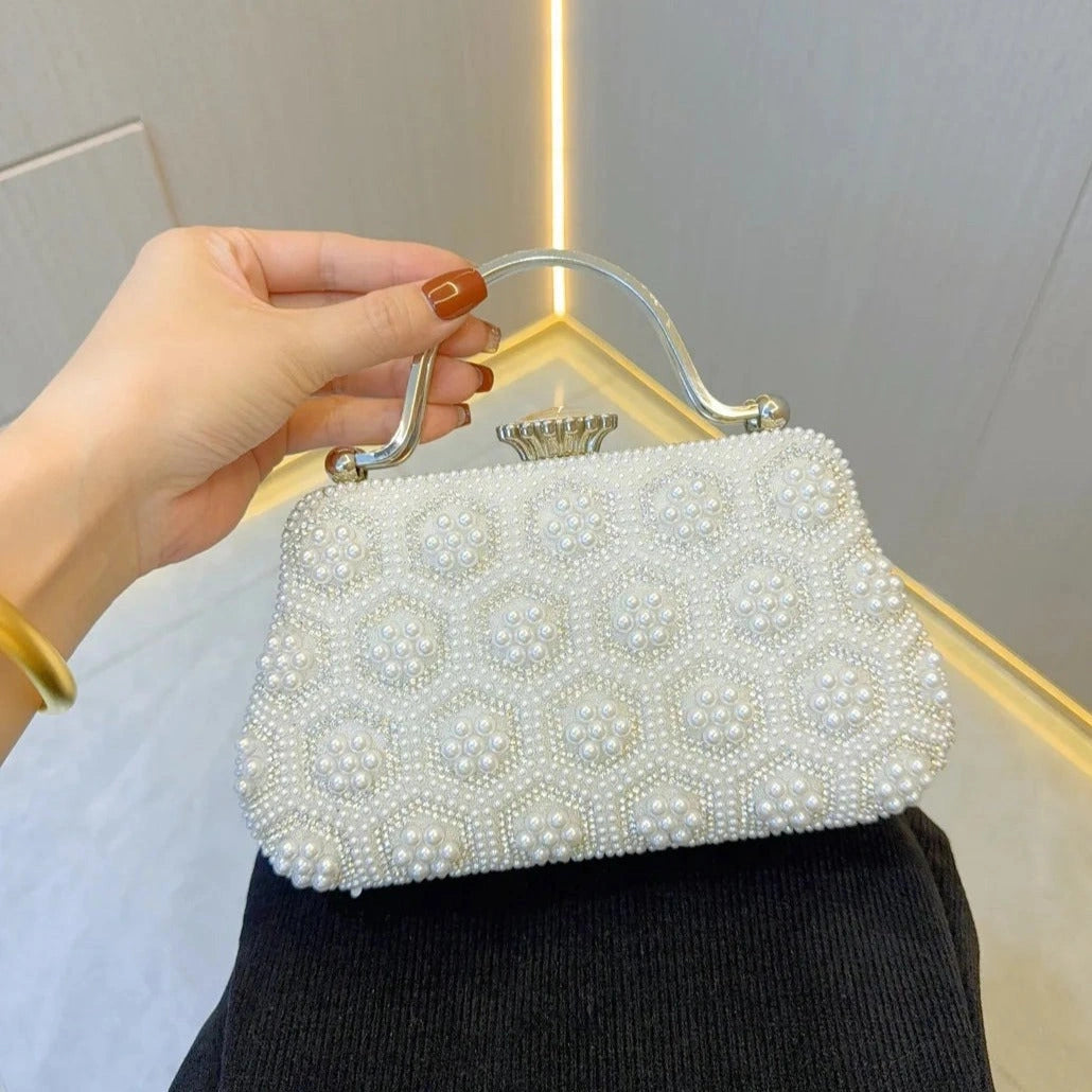 Elegant pearl clutch bag featuring a smooth finish, adorned with delicate clasp, shown — view 2 — view 2