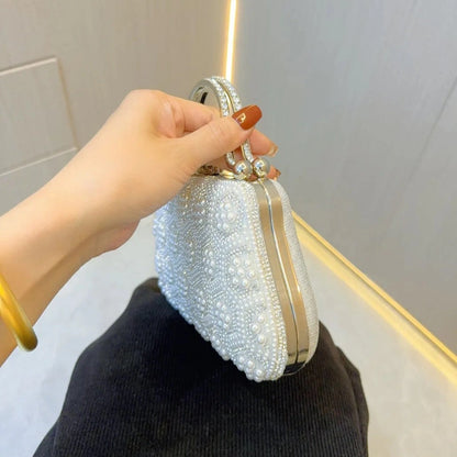 Elegant pearl clutch bag featuring a smooth finish, adorned with delicate clasp, displayed — view 3 — view 3