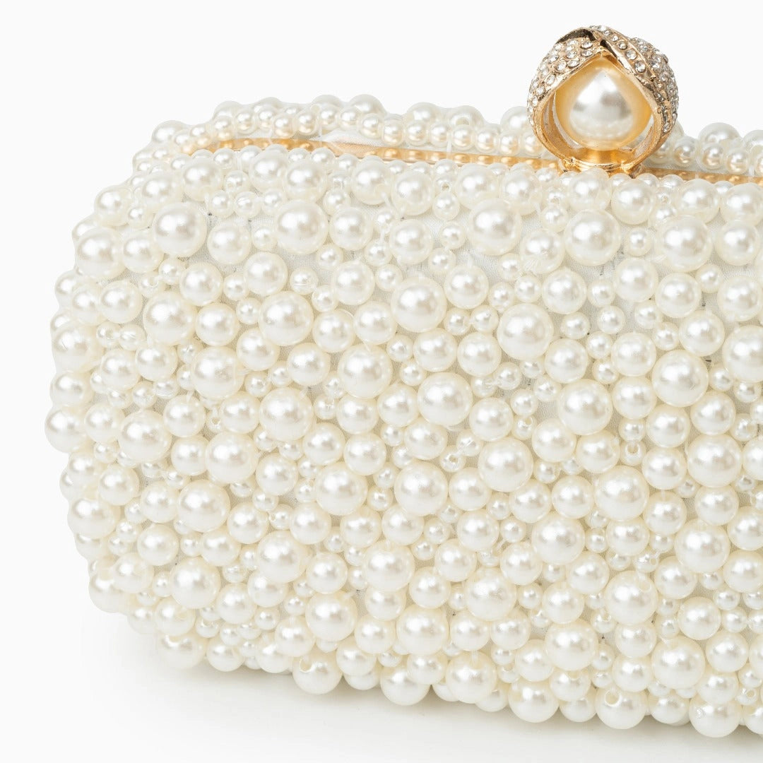 Elegant pearl clutch bag featuring a soft, textured surface and sleek, compact design, showcasing side view — 2 — view 2