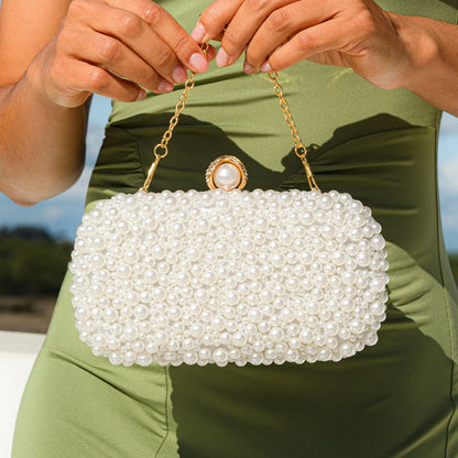 Elegant pearl clutch bag featuring a smooth finish and delicate clasp, showcasing sophisticated design — view 3 — view 3