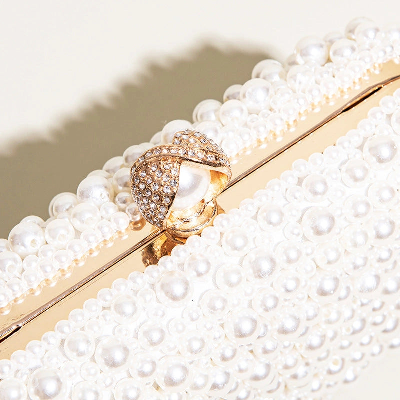 Elegant pearl clutch bag featuring a soft, textured exterior and sleek, compact design, showcasing delicate clasp — view 6