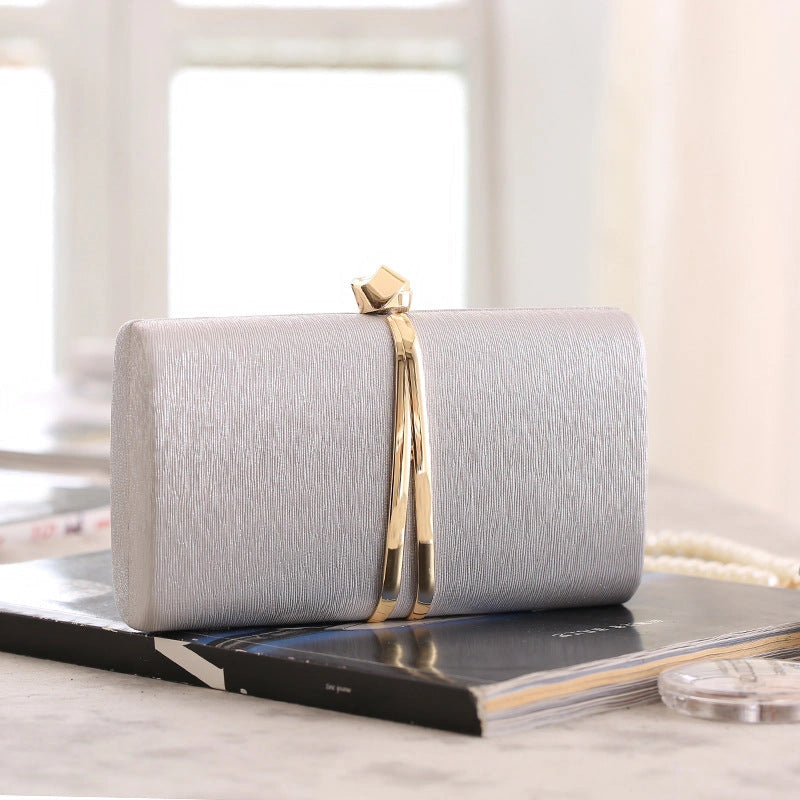 Elegant clutch bag in soft cream leather with a textured finish, featuring sleek silhouette and gold tone clasp — view 10