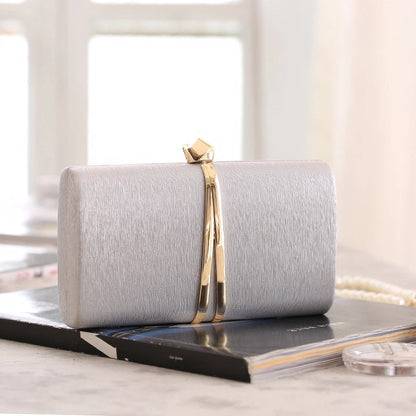 Elegant clutch bag in soft cream leather with a textured finish, featuring sleek silhouette and gold tone clasp — view 10