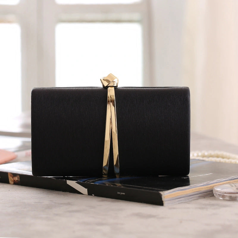 Elegant clutch bag in a soft metallic finish, featuring sleek silhouette and detachable chain strap, front view — view 13