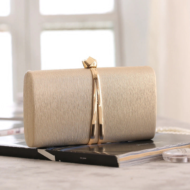 Elegant clutch bag in a soft beige fabric, featuring sleek design and subtle clasp closure, front view — 2 — view 2