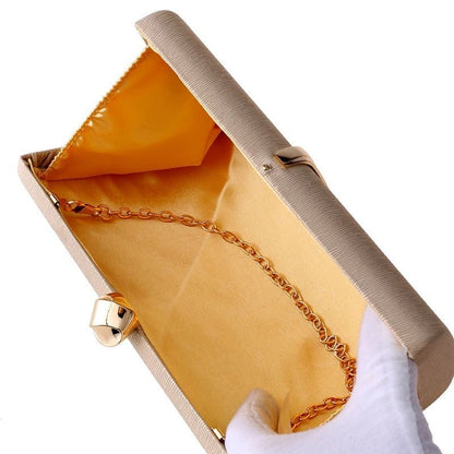 Elegant clutch bag in deep burgundy with a sleek, textured finish and gold clasp, showcasing sophisticated design — view 5