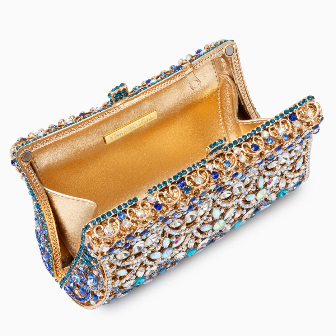 Elegant clutch bag in soft beige leather with a textured finish, featuring gold tone clasp and detachable chain — view 4