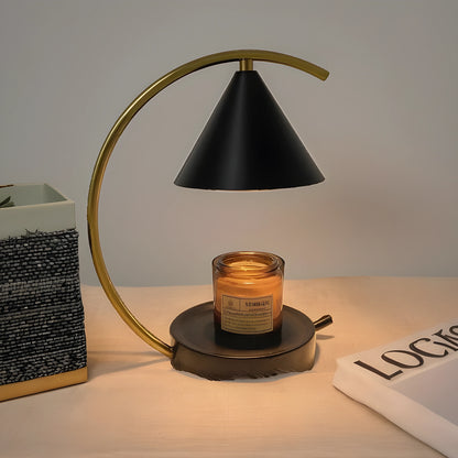 View of a sculptural dimmable candle warmer table lamp featuring a textured ceramic base in earthy tones and a warm glow